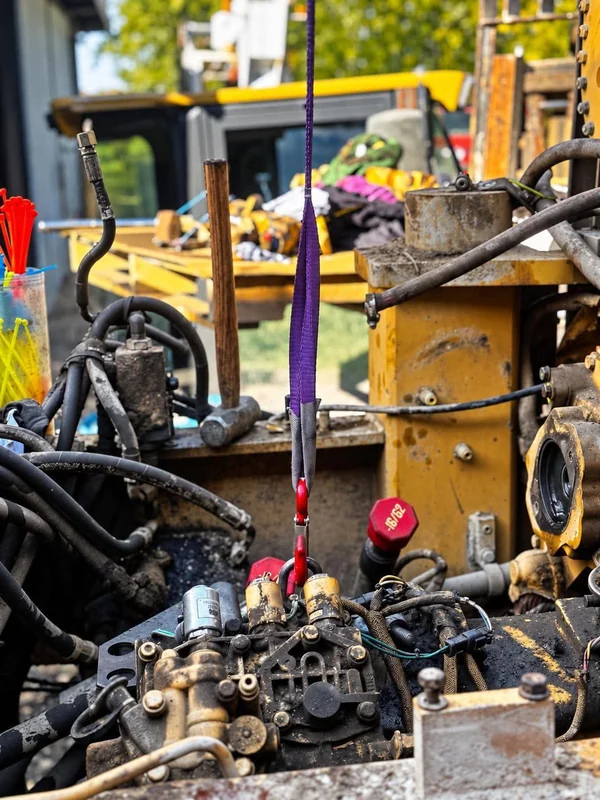 Hydraulic lines and fittings on a yellow machine during a repair
